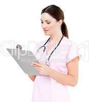 Beautiful female doctor writing her diagnosis