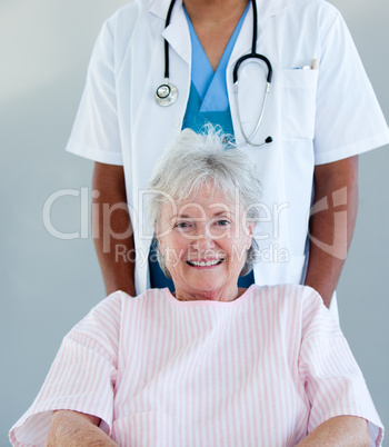 Smiling senior patient sitting on a wheelchair