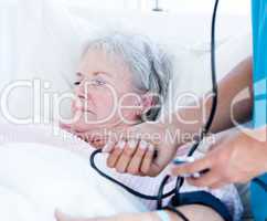 Sick senior woman lying on a hospital bed