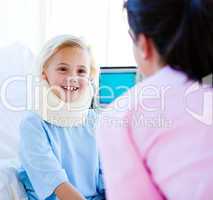 Adorable little girl with a neck brace talking with a nurse