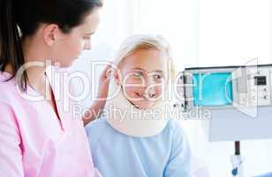 Adorable little girl with a neck brace sitting with her nurse