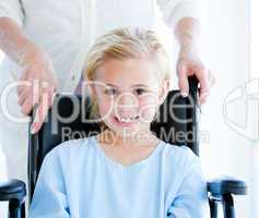 Adorable little girl sitting on a wheelchair