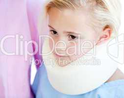 Close-up of a little girl with a neck brace