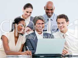 Happy mixed businessteam looking at the laptop