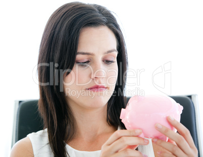 Beautiful businesswoman holding a piggybank