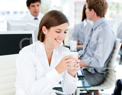 Smiling businesswoman holding a cup of coffee