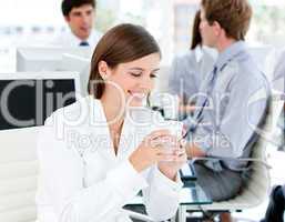 Smiling businesswoman holding a cup of coffee