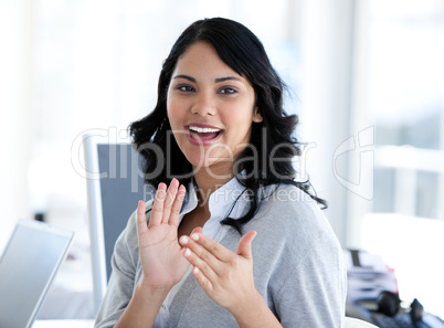 Portrait of a cute businesswoman applaudising a new colleague