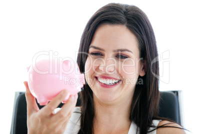 Laughing businesswoman holding a piggybank