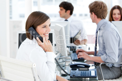 Enthousiastic businesswoman talking to the phone