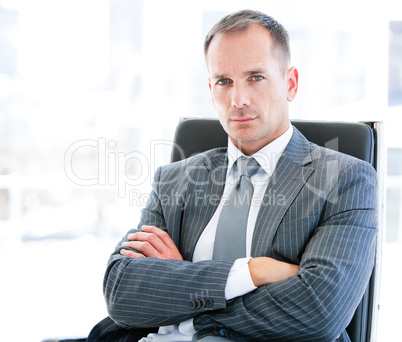 Confident businessman looking at the camera sitting