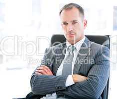 Confident businessman looking at the camera sitting