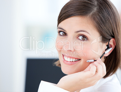 Cute businesswoman talking with clients in front of her computer