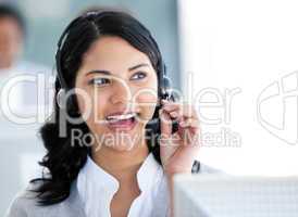 Beautiful businesswoman talking with clients in front of her com