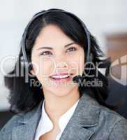 Smiling businesswoman wearing a headset to talk with customer