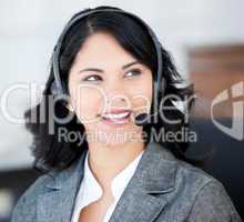 Attractive businesswoman wearing a headset to talk with customer