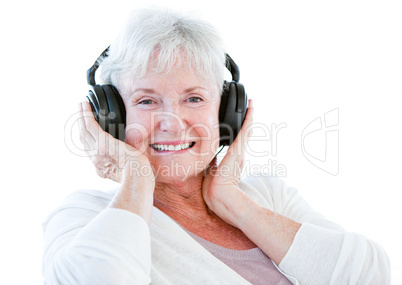 Smiling senior woman listening music with headphones