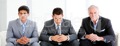 Three charismatic businessmen in a waiting room