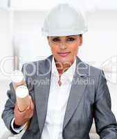 Confident female architect holding blueprints