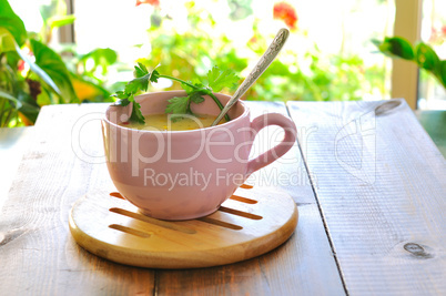 A cup of soup on a background of green