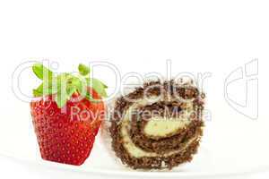 strawberries and cake roll isolated on white