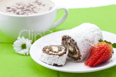 Roll cake and strawberries on a plate