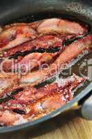 Bacon frying in a pan