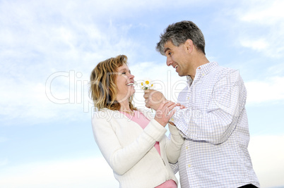 Mature romantic couple with flowers