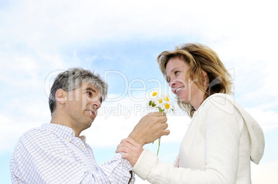 Mature romantic couple with flowers