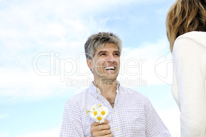 Mature romantic couple with flowers