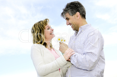 Mature romantic couple with flowers