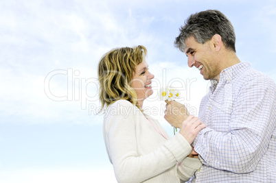 Mature romantic couple with flowers