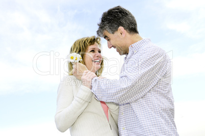 Mature romantic couple with flowers