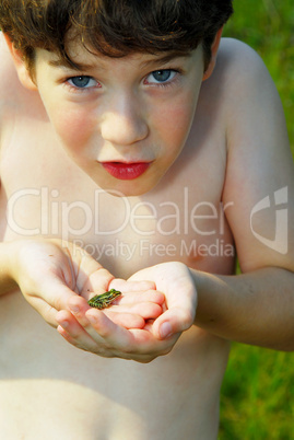 Boy holding a frog