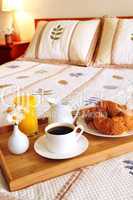 Breakfast on a bed in a hotel room