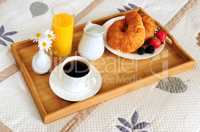 Breakfast on a bed in a hotel room