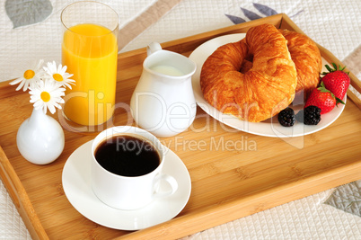 Breakfast on a bed in a hotel room