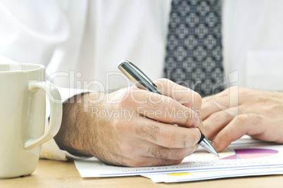 Office worker writing on reports