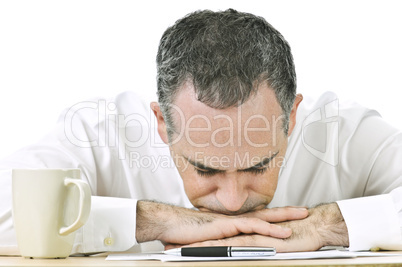 Businessman resting head on hands