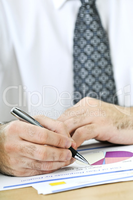 Office worker writing on reports