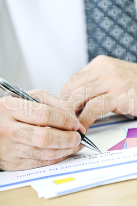 Office worker writing on reports