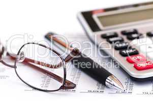 Tax calculator pen and glasses