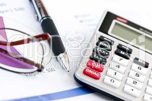 Tax calculator pen and glasses