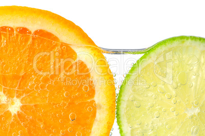 Orange and lime slices in water
