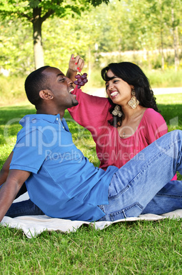 Happy couple having picnic in park