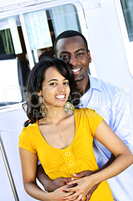 Happy couple in front of yacht