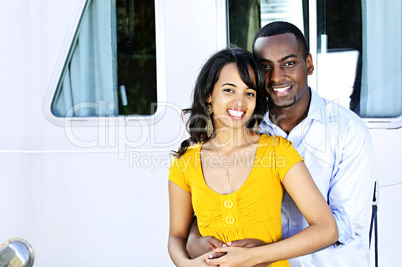 Happy couple in front of yacht