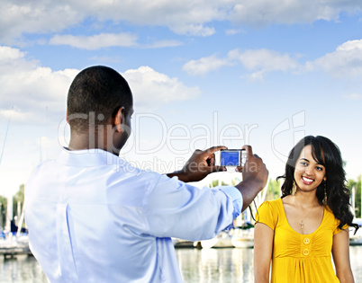 Woman posing for picture near boats