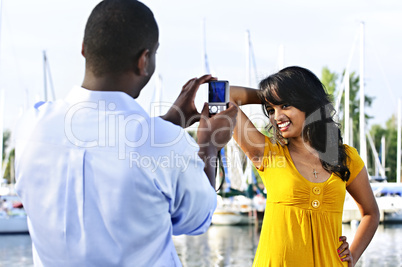 Woman posing for picture near boats