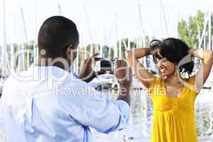 Woman posing for picture near boats